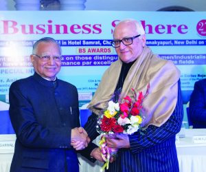 K L Malhotra Advisor presenting a bouquet to H E Mr K L Ganju ocvc Cdr Consul General HY Advisor to The Foreign Minister Union of Comoros